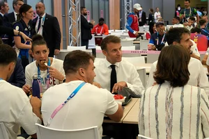 | Photo: AP/Michel Euler, Pool : Emmanuel Macron with French athletes